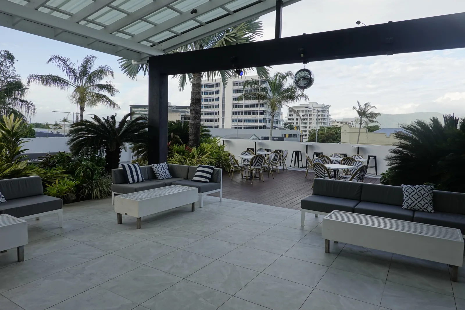 Terrace tables beside the pool at The Benson Hotel Cairns